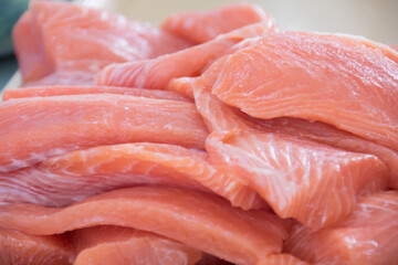 Preparing sushi with Raw salmon steak, rice and fresh avocados
