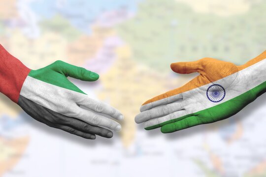 United Arab Emirates and India - Flag handshake symbolizing partnership and cooperation