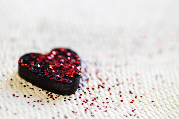 black heart with red glitter. concept of self love