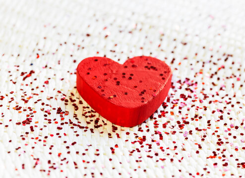 red wooden love heart with red glitter. concept of happiness
