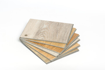 Stack of sample PVC vinyl wood planks on white background.