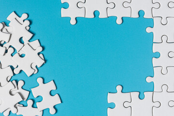 White jigsaw puzzle on blue background.