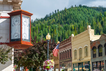 An antique clock showing time and temperature on the corner of a vintage building in the historic mining town of Wallace, Idaho, USA