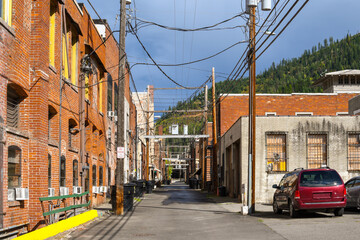 Fototapeta na wymiar A mass of electrical wires and poles in a back alley of the historic mining town of Wallace, Idaho, USA