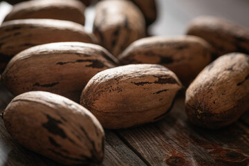 Pecan Nuts In Shell On Wood Table