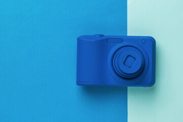 Beautiful blue camera on a two-color background.