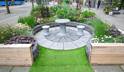 Temporary Sidewalk roadside outdoor garden and resting area. Gothenburg, Sweden.  Part of an experimental urban greening initiative.