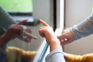 Hands of adult and kids on the touchscreen of multimedia kiosk. Education, learning and technology...