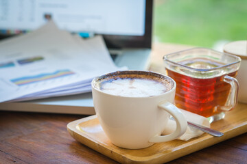 Coffee mugs on work desks and laptops