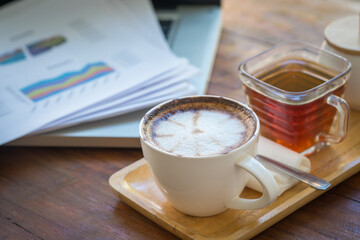 Coffee mugs on work desks and laptops