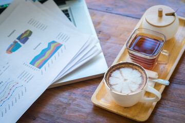 Coffee mugs on work desks and laptops