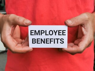 Selective focus image with noise effect hand holding white card with text EMPLOYEE BENEFITS.