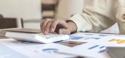 Accounting businesswomen are calculating income-expenditure and analyzing real estate investment data, Dedicated to the progress and growth of the company, Financial and tax systems concept.