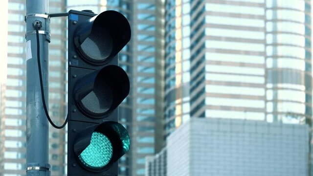 Traffic light turns from red to green at financial district intersection. 