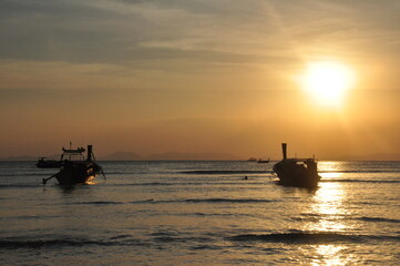 fishing boats at sunset