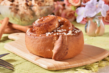 Freshly baked cinnamon roll dusted with powdered sugar