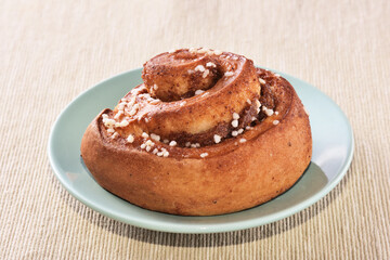 Freshly baked cinnamon roll dusted with powdered sugar