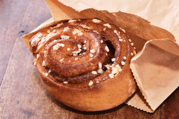 Freshly baked cinnamon roll dusted with powdered sugar
