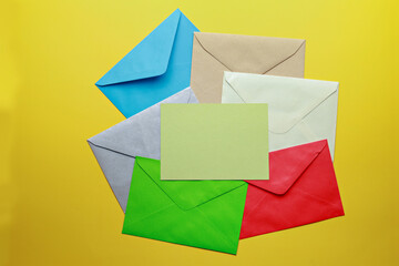 Blank postcard and envelope isolated on yellow background. Top view