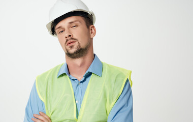 construction worker in white helmet and green reflective vest