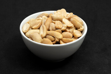 Unsalted peanuts in a white bowl