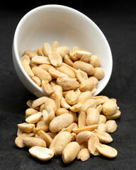 Unsalted peanuts in a white bowl