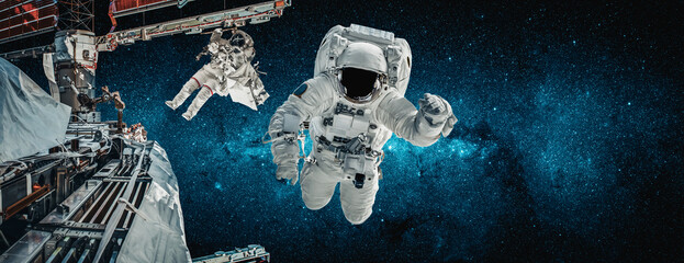 Astronaut spaceman do spacewalk while working for space station in outer space . Astronaut wear...
