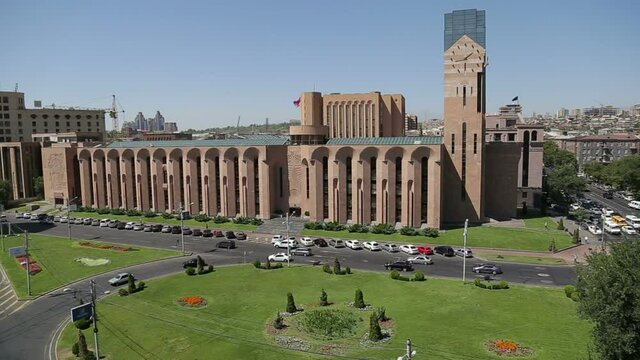 Panorama of the city from the roof. Yerevan city hall building, streets with cars and a park.
