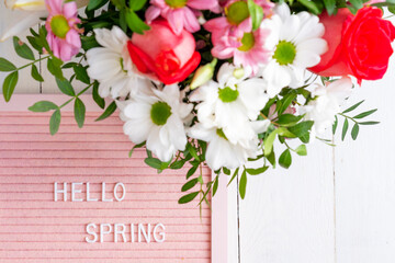 Quote - Hello spring. Border frame made of blooming flowers on a white background