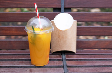 orange lemonade on a park bench