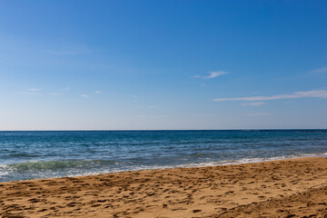 Fototapeta na wymiar Sea beach with sand and waves. Sunny day.