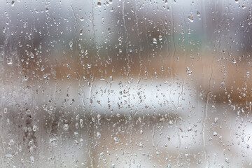 Raindrops on the glass window as a background.