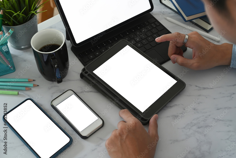Aufkleber close up view of young man using multiple devices with empty screen on marble table. blank screen fo