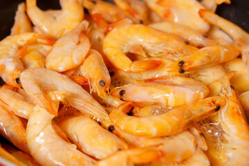 red shrimps with heads on the pan close-up in selective focus. sea food