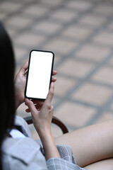 Portrait of young asian woman relaxing at cafe and using mobile phone.