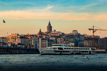 Cruise ferries in Bosphorus between european and asian coasts of Istanbul. Galata Tower in the distance. Turkey.