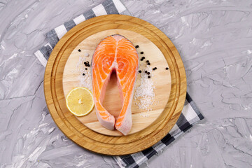 Raw Salmon steak on Grey concrete background. Preparation food, top view. Copy space