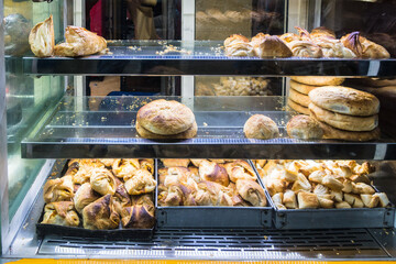 Baked pastries on glass shelf display in Chennai