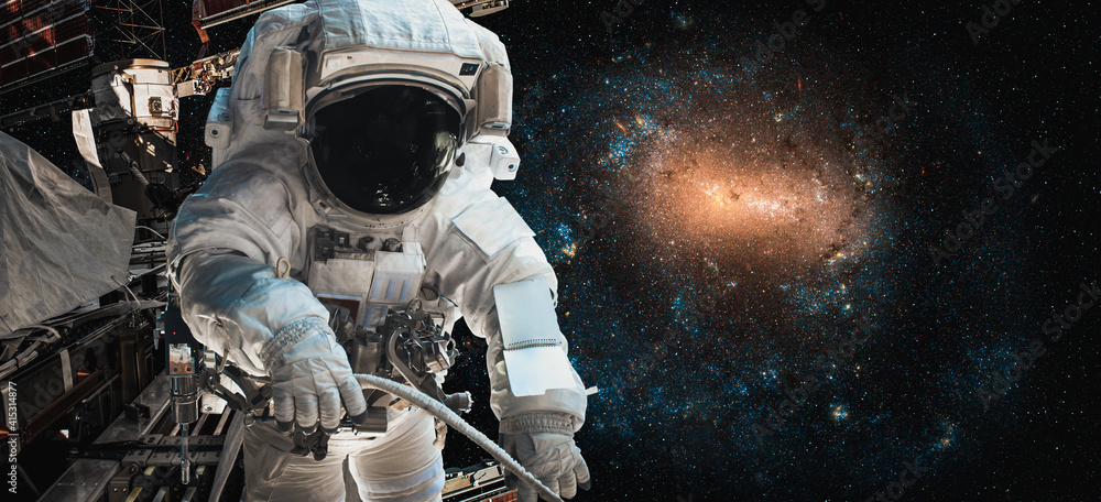 Wall mural astronaut spaceman do spacewalk while working for space station in outer space . astronaut wear full