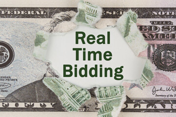 The dollar is torn in the center. In the center it is written - Real Time Bidding