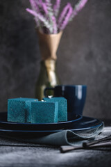 Blue cake filled with orange and tangerine in the shape of a cube. Rustic style.