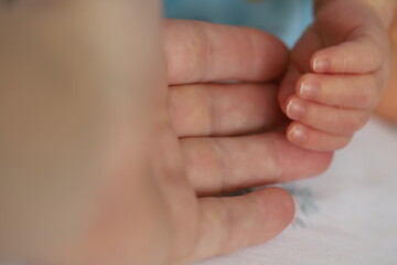 Obraz na płótnie Canvas small baby hand with creases newborn baby hand