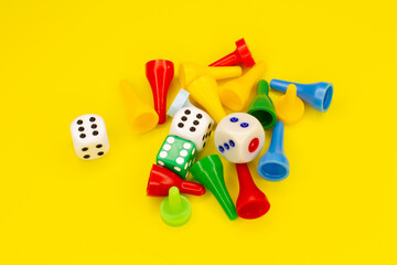 Game pieces with game cubes on a yellow background. Board games