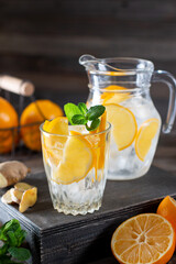 Lemonade with fresh lemon and mint in glass jug