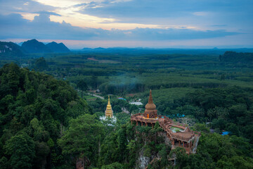 Khao Na Nai Luang Tham Park. Pagoda at sunrise on the top at Khao Na Nai Luang Dharma Park with fog. Beautiful Temple at Surat Thani province, Thailand.