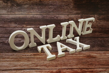 Online Tax word alphabet letters on wooden background