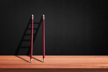 Red pencil on wall have a stairs shadow is shape. concept of effort business to be successful. Stairway to light for background....