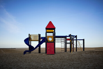 Modern and colorful play area on a Belgian beach in the early morning of a beautiful winter day