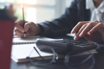 Business and finance concept, Business woman using calculator to calculate business data during...