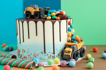 Birthday colorful cake for little boy with toy cars and colorful candies decorations. Holiday,...